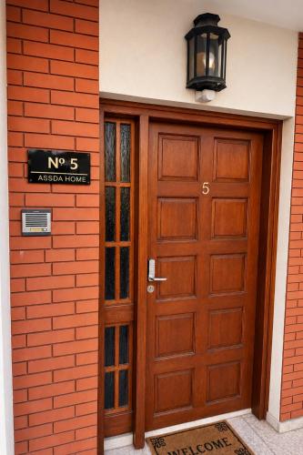 a wooden garage door with a no sign on a building at Smart Comfort RoomN3 with Private Bathroom in best Location Beach 250m in Limassol