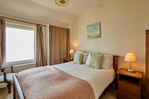 a bedroom with a large bed and a window at Host & Stay - The Beach in Filey