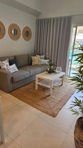 a living room with a couch and a coffee table at Xonadu con dominio in Puerto Plata