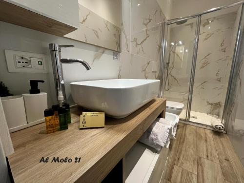 a bathroom with a white sink and a shower at Al molo 21 in La Spezia