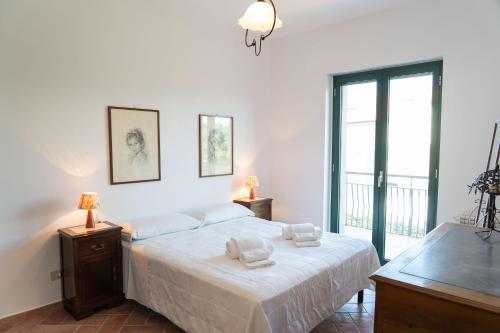 a bedroom with a bed with two towels on it at Cresta Panoramic apartments in Naso