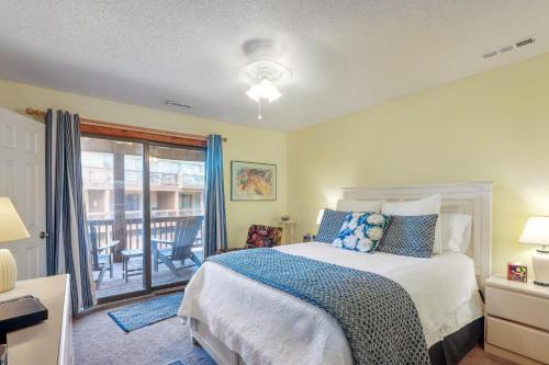 a bedroom with a bed and a balcony at The Gallery in Kitty Hawk