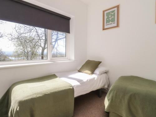 a bedroom with two beds and a window at Beacon Fell Cottage 1 in Preston