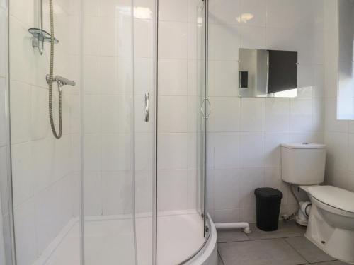 a bathroom with a shower and a toilet at Beacon Fell Cottage 1 in Preston