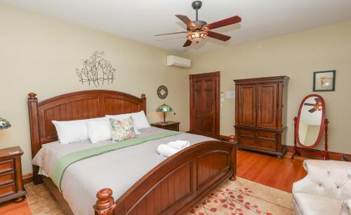 a bedroom with a large bed and a ceiling fan at Willough Bed and Breakfast in Conshohocken