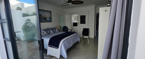 a bedroom with a bed and a vase in a room at Sonrisa on Point in Stompneusbaai