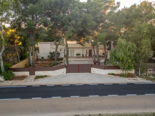 a house with a fence in front of a road at Villa Fefè in Nardò