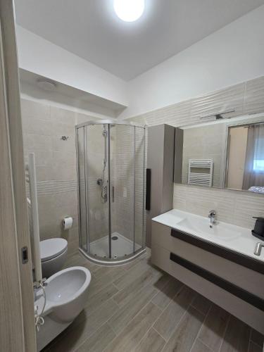 a bathroom with a shower and a toilet and a sink at Levante Land & Sea in Bari