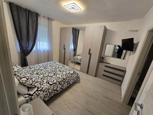 a small bedroom with a bed and a mirror at Levante Land & Sea in Bari