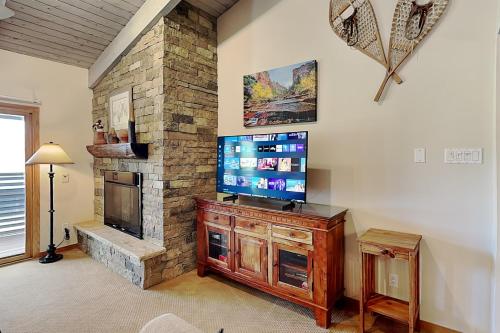 a living room with a fireplace and a flat screen tv at Timberline Condominiums 1 Bedroom plus Loft Deluxe Unit D3B in Snowmass Village