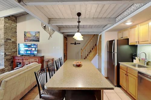 a kitchen and dining room with a table and a couch at Timberline Condominiums 1 Bedroom plus Loft Deluxe Unit D3B in Snowmass Village