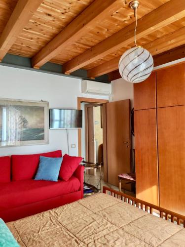 a red couch sitting in a living room at Bed & Breakfast Lucy in Bardolino