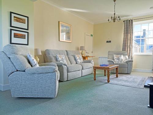 a living room with two couches and a table at Thelma's House - Uk48886 in Belford