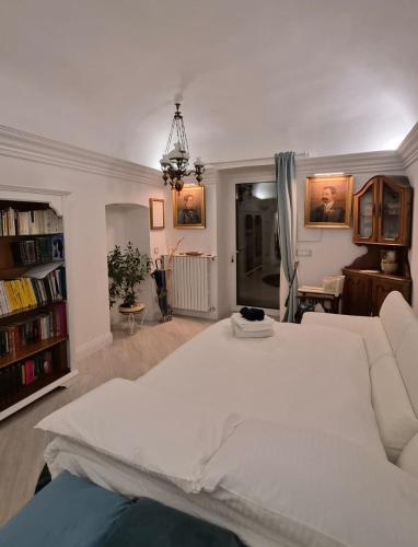 a bedroom with a large white bed and a living room at Marè Sunrise in Bari