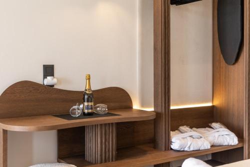 a bottle of champagne on a table with towels at Iliovasilema Studios in Mytakas