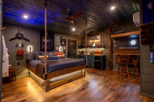 a bedroom with a bed hanging from a ceiling at "Air Fort One" Aviation-Themed Luxury Treehouse Near Dollywood & Pigeon Forge in Sevierville