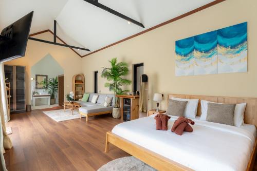 a bedroom with a bed and a living room at Palmcove Chiang Mai Old Town in Chiang Mai