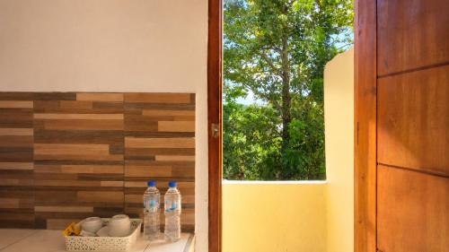 a room with a window with water bottles on a counter at Ocha Bajo Homestay in Komodo Labuan Bajo Airport