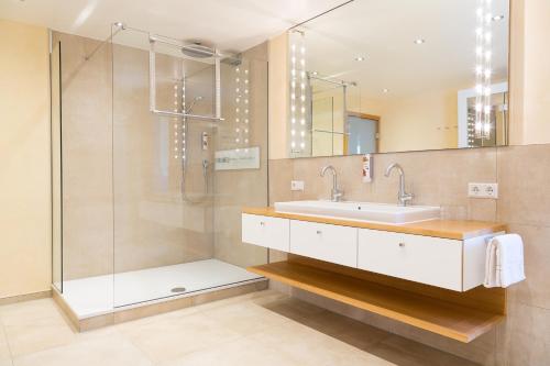 a bathroom with a sink and a shower at Hotel-Restaurant Schwedi in Langenargen