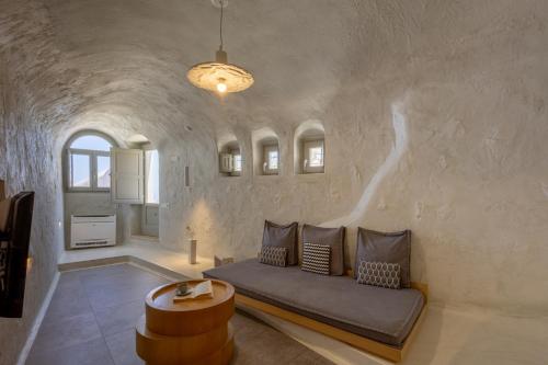a living room with a couch and a table at Santorini Soul Villas in Pyrgos