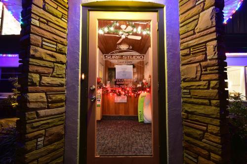a door leading into a store with christmas lights at Surf Studio Beach Resort in Cocoa Beach
