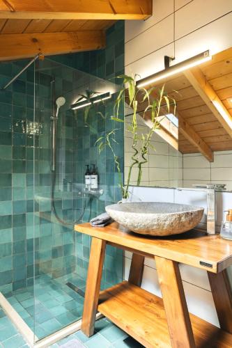 a bathroom with a stone sink and a shower at The Hidden Attique in Corfu