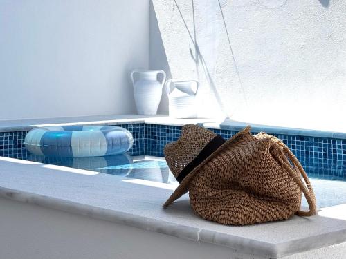 a purse sitting on a ledge next to a swimming pool at OLIA STUDIOS Olga studios in Faliraki