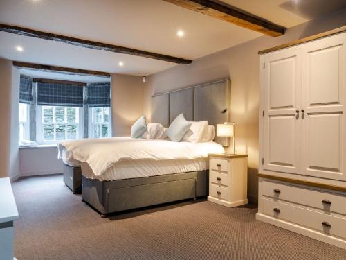 a bedroom with a large bed and a white cabinet at Prospect House in Windermere