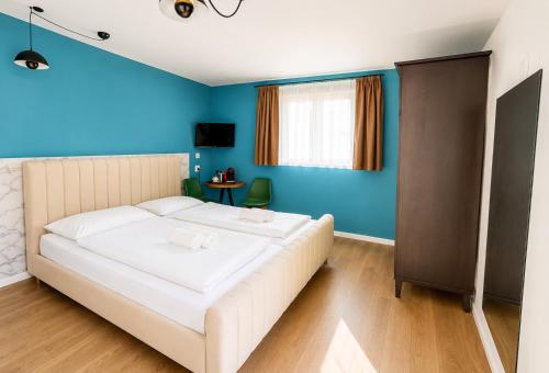 a bedroom with a white bed and blue walls at Moder Studio Nr15 in Limassol