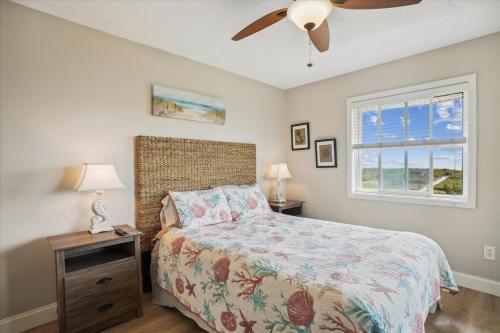 a bedroom with a bed and a ceiling fan at Tidewater Star Unit 2i in Duck