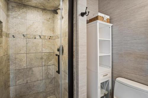 a shower with a glass door in a bathroom at Tidewater Star Unit 2i in Duck