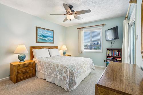 a bedroom with a bed and a ceiling fan at Duck Legacy Unit 2E in Duck