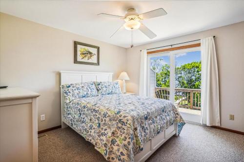 a bedroom with a bed and a window at Emerald Duck in Duck