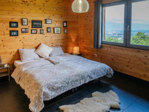 a bedroom with a bed in a wooden wall at St Barbara Hideaway in Škofja Loka