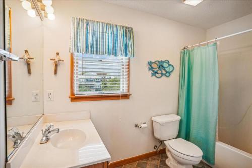 a bathroom with a toilet and a sink at Duck Views in Duck