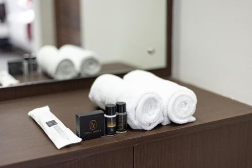 a counter with towels and cosmetics on it at Hotel Livora in Alwaye