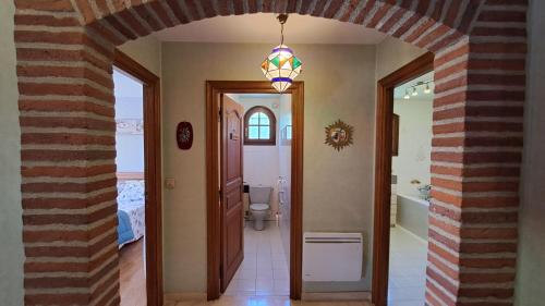 a hallway with a room with a bathroom with a toilet at Chez tatie Jacqueline in Albi