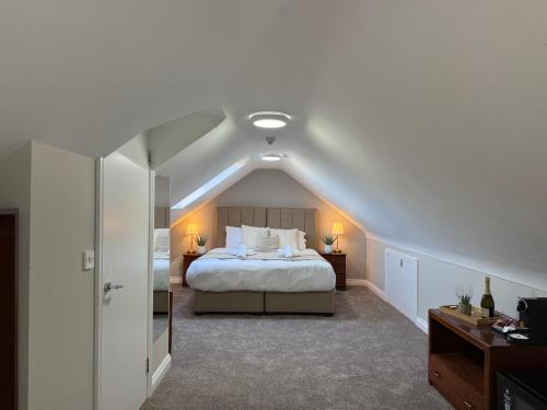 a bedroom with a large bed in a attic at All Seasons Guesthouse in Belfast