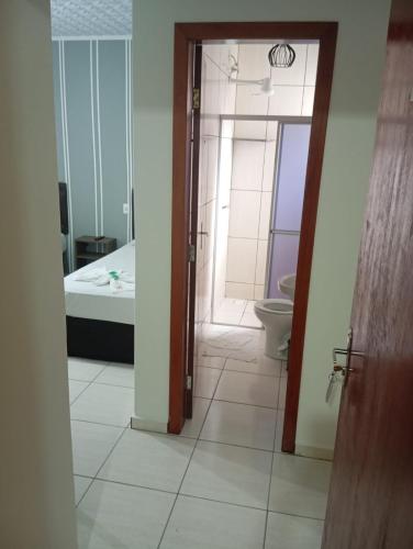 a bathroom with a shower and a toilet in a room at Hotel Maciel in Ponta Grossa