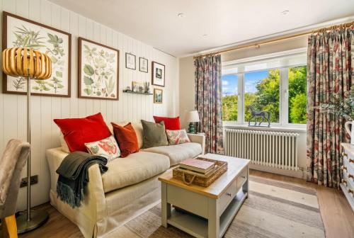 a living room with a couch and a window at Beautiful New Forest Hideaway in West Wellow
