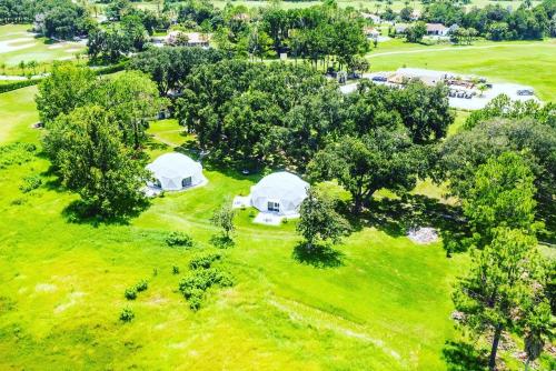 an overhead view of tents on a field with trees at ROOM 03 - Lake Sumner in Clermont