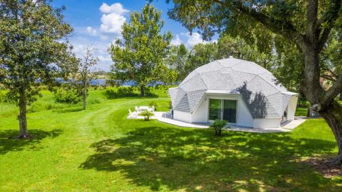 a white dome house in a field with trees at STUDIO 05 - Lake Sumner in Clermont