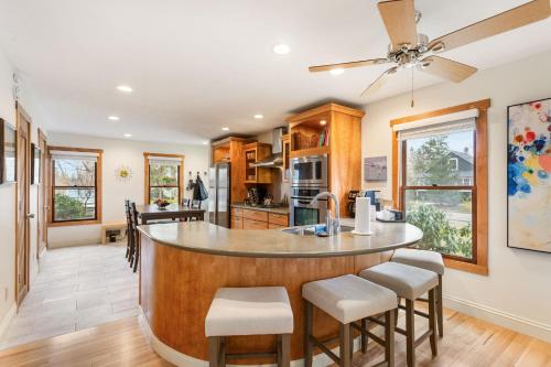 a kitchen with a large island with stools at Bird's Nest -2BR Downtown Saugatuck Walkable in Saugatuck
