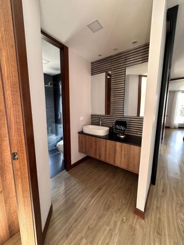 a bathroom with a tub and a sink and a mirror at Casa con vista a cuenca in Cuenca