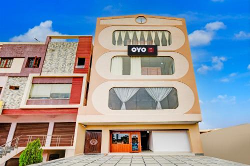 an apartment building with an ovo sign on it at Hotel O Inn In Town in Sangāreddi