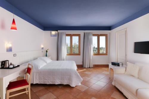 a bedroom with a bed and a couch at Marin Hotel in Pula