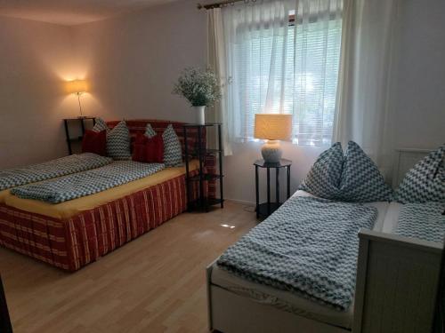 a living room with two beds and a window at Apartment FreiRaum in Innsbruck