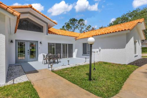 a white house with an orange roof at SWISS 101 - Lake Olsen in Clermont