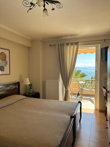 a bedroom with a bed and a view of the ocean at Palatino in Loutra Edipsou