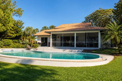 a house with a swimming pool in the yard at SWISS 28 - Lake Stephanie in Clermont